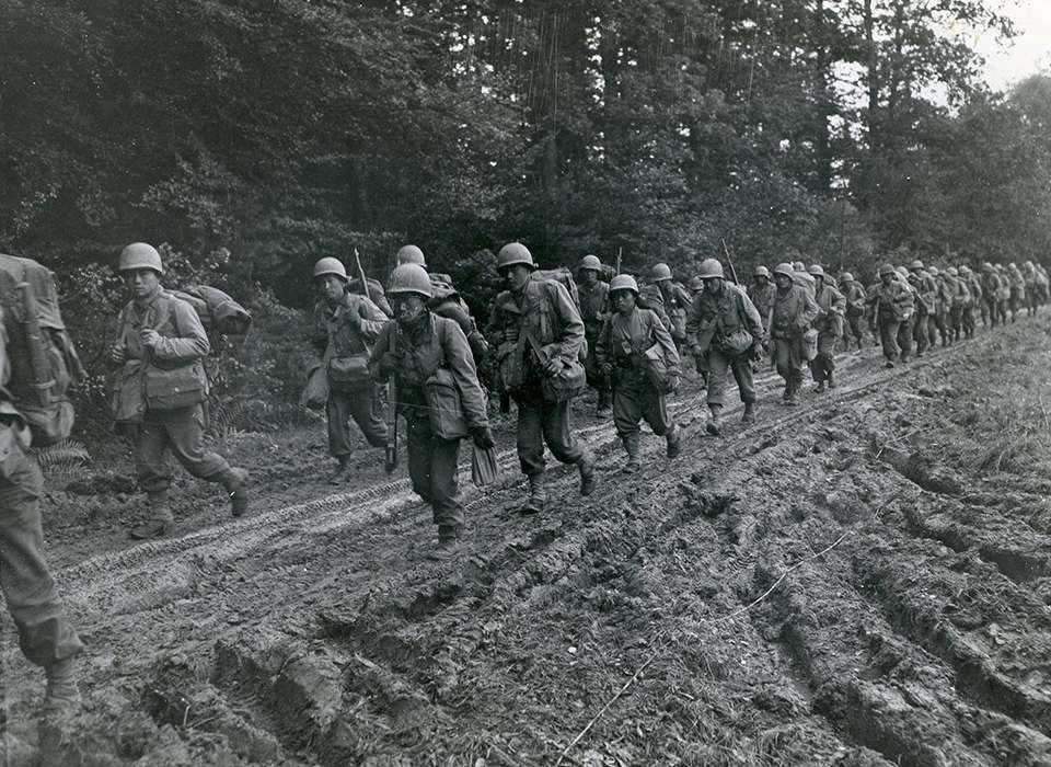 442nd combat team margching in the woods, France.