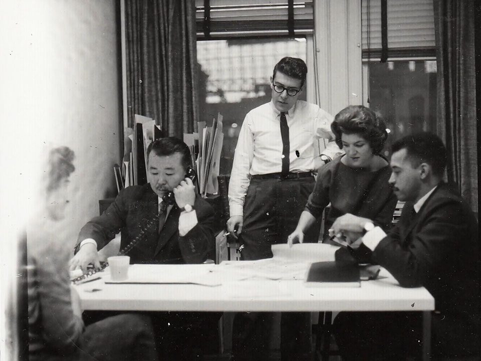 Fujita, making a call on the phone while meeting with his colleagues at Clumbia Records.