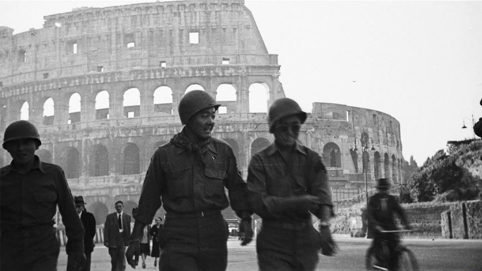 Two 442nd Regimental Combat members standing in the street of one of the liberated city in Europe.