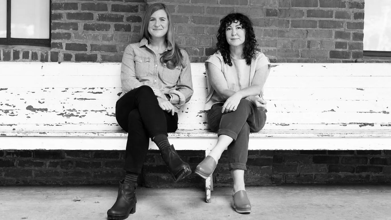 Tow women sitting on the bench: Phoebe Judge, the host and the author sitting the left. Lauren Spohrer, the co-creator of Criminal Productions on the right