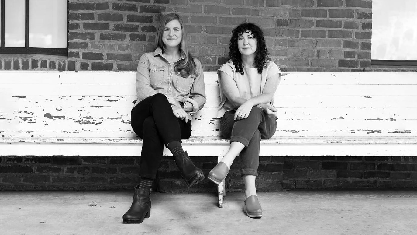 Tow women sitting on the bench: Phoebe Judge, the host and the author sitting the left. Lauren Spohrer, the co-creator of Criminal Productions on the right