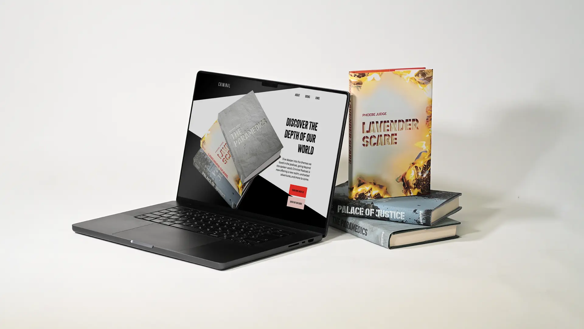 A stack of Criminal books and a laptop showing the landing page.